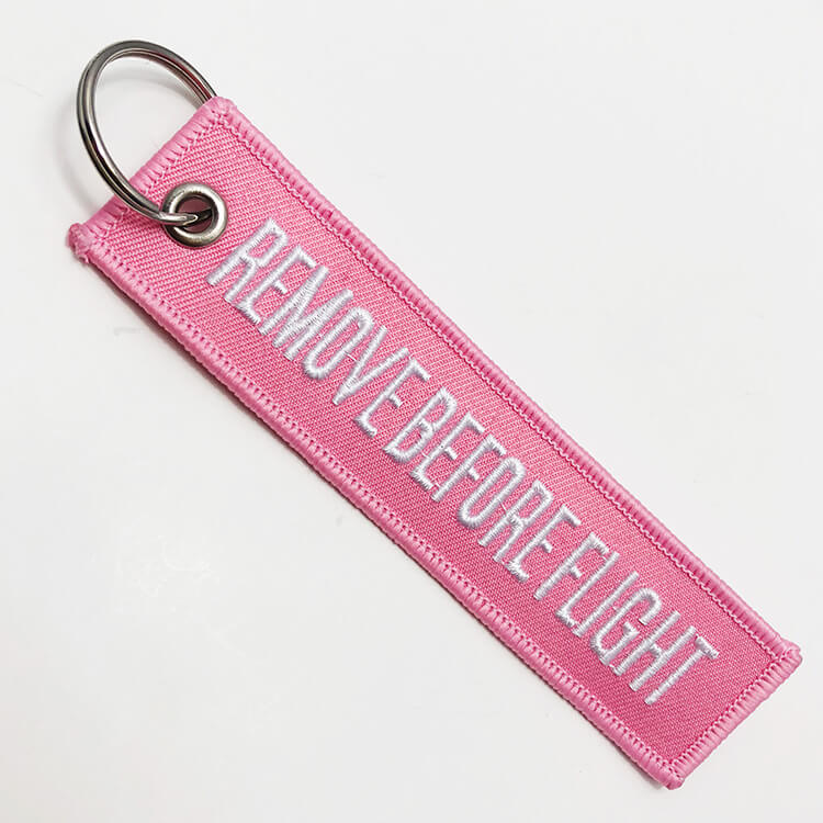 Cheap custom made embroidered remove before flight keychain