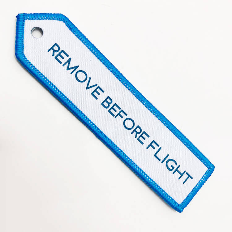 embroidered remove before flight keychain