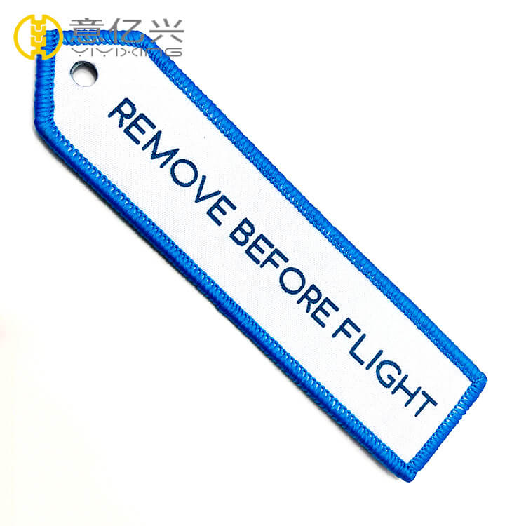 embroidered remove before flight keychain