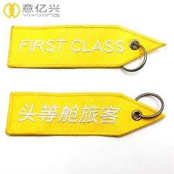 Personalized yellow embroidered flight keychain with name tag