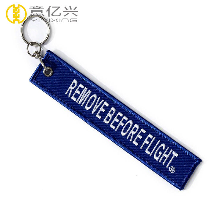 embroidered remove before flight keychain