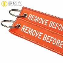 Fashionable double side customized remove before launch keychains