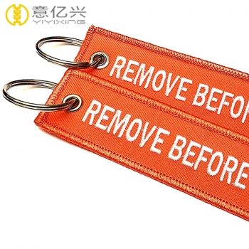 Fashionable double side customized remove before launch keychains