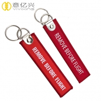 Custom woven fabric keychain remove before flight tags for sale