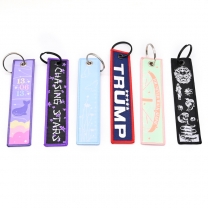 Custom Slogan Logo Woven Printed Keychain Business Promotional Items Embroidery Japan Jet Tag Keychain